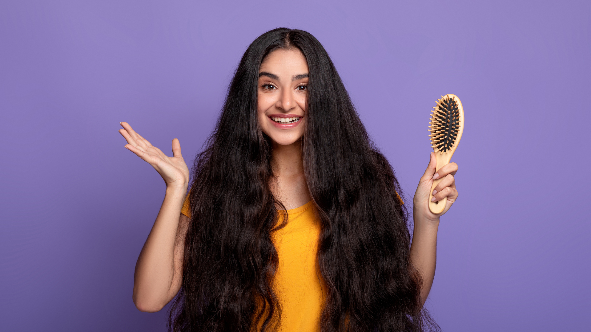 An image of a woman showing off her strong and shiny hair.